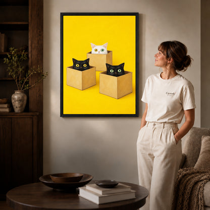 Cats in boxes canvas art shown in the black frame option against a softly lit wall.
