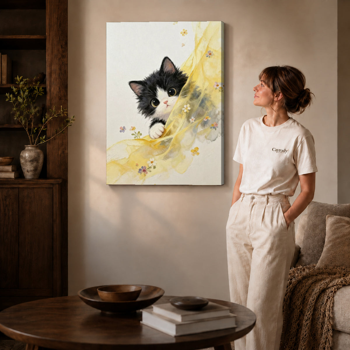 Curious kitten canvas art on gallery-wrapped canvas with natural edge shading beside a standing woman.