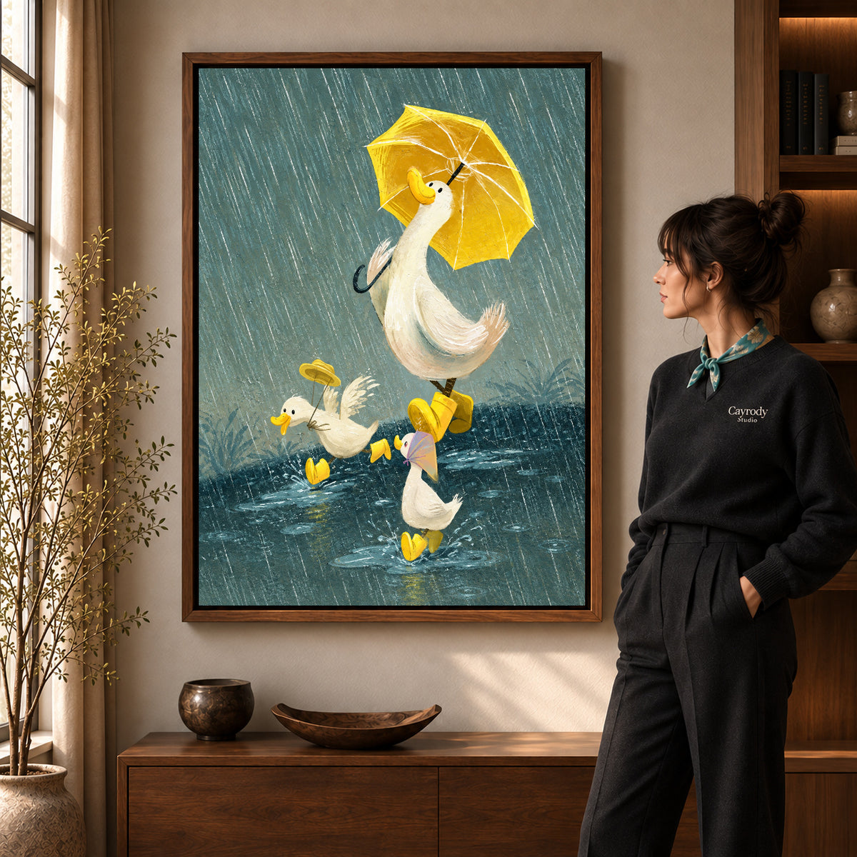 Rainy ducks canvas art in a walnut frame beside a standing woman and wooden console.