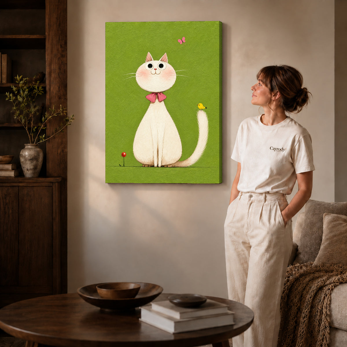 White cat canvas art on gallery-wrapped canvas with visible depth beside a woman in a warm living room.