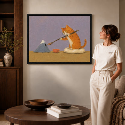 Painter cat canvas art in a black frame beside a woman and round wooden table.