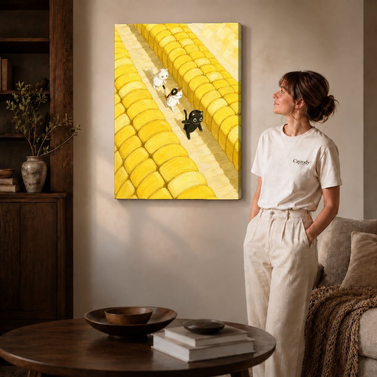 Farm cats canvas art on gallery-wrapped canvas with natural edge shading beside a standing woman.