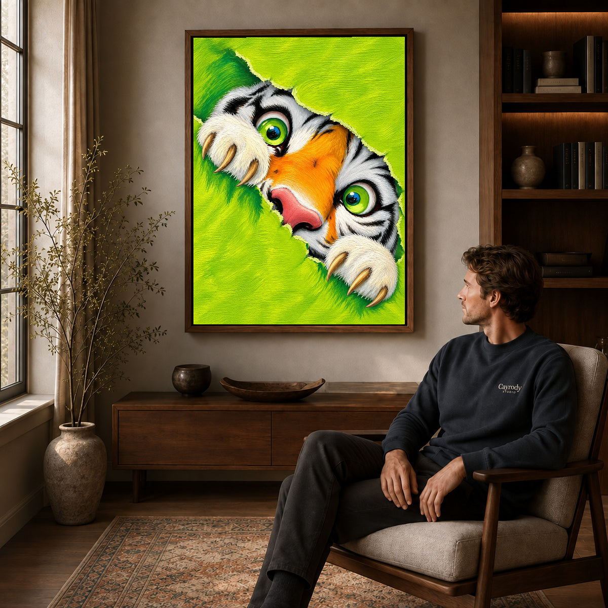 Peeking tiger canvas art in a walnut frame above a console beside a seated man.