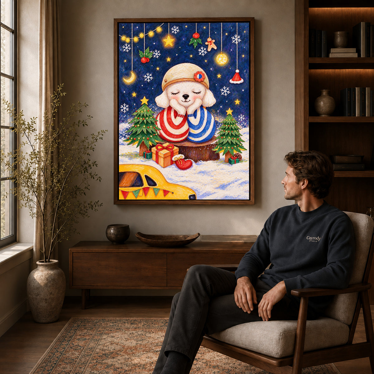 Christmas puppy canvas art in a walnut frame above a console beside a seated man.