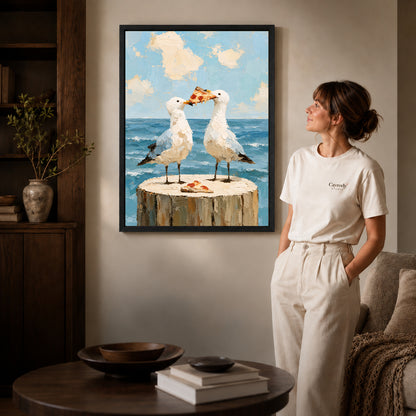 Seagull pizza canvas art in a black frame beside a woman and round wooden table.