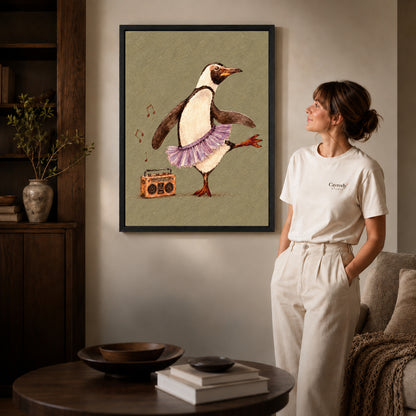 Dancing penguin canvas art in a black frame beside a woman and round wooden table.