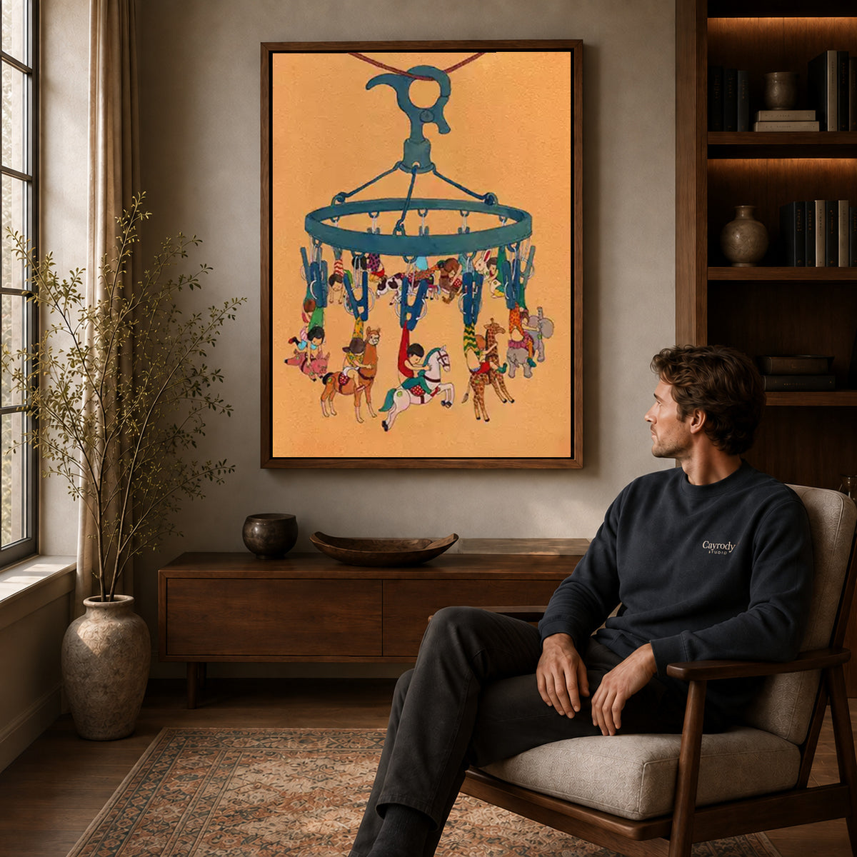 Hanging carousel canvas art in a walnut frame above a console beside a seated man.