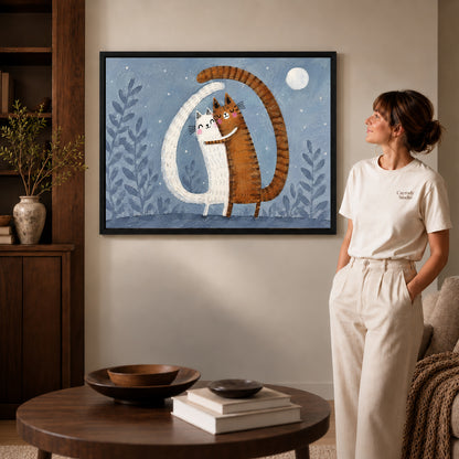 Hugging cats canvas art in a black frame above a round table beside a standing woman.