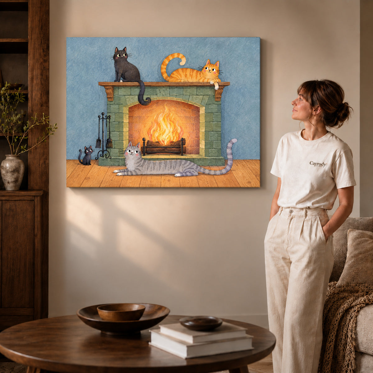 Fireplace cats canvas art on gallery-wrapped canvas with natural edge shading beside a standing woman.