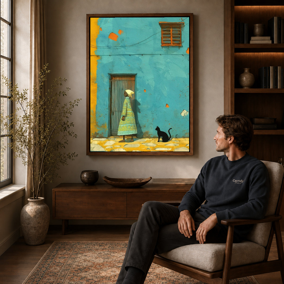 Turquoise street canvas art in a walnut frame above a console beside a seated man.