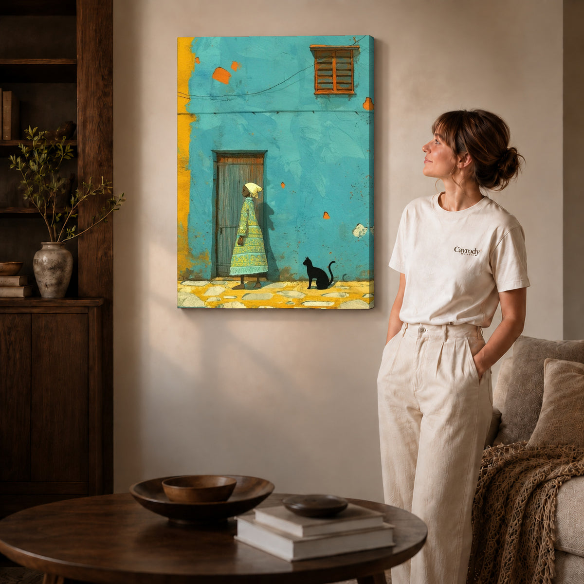 Turquoise street canvas art on gallery-wrapped canvas with visible depth beside a woman in a warm living room.