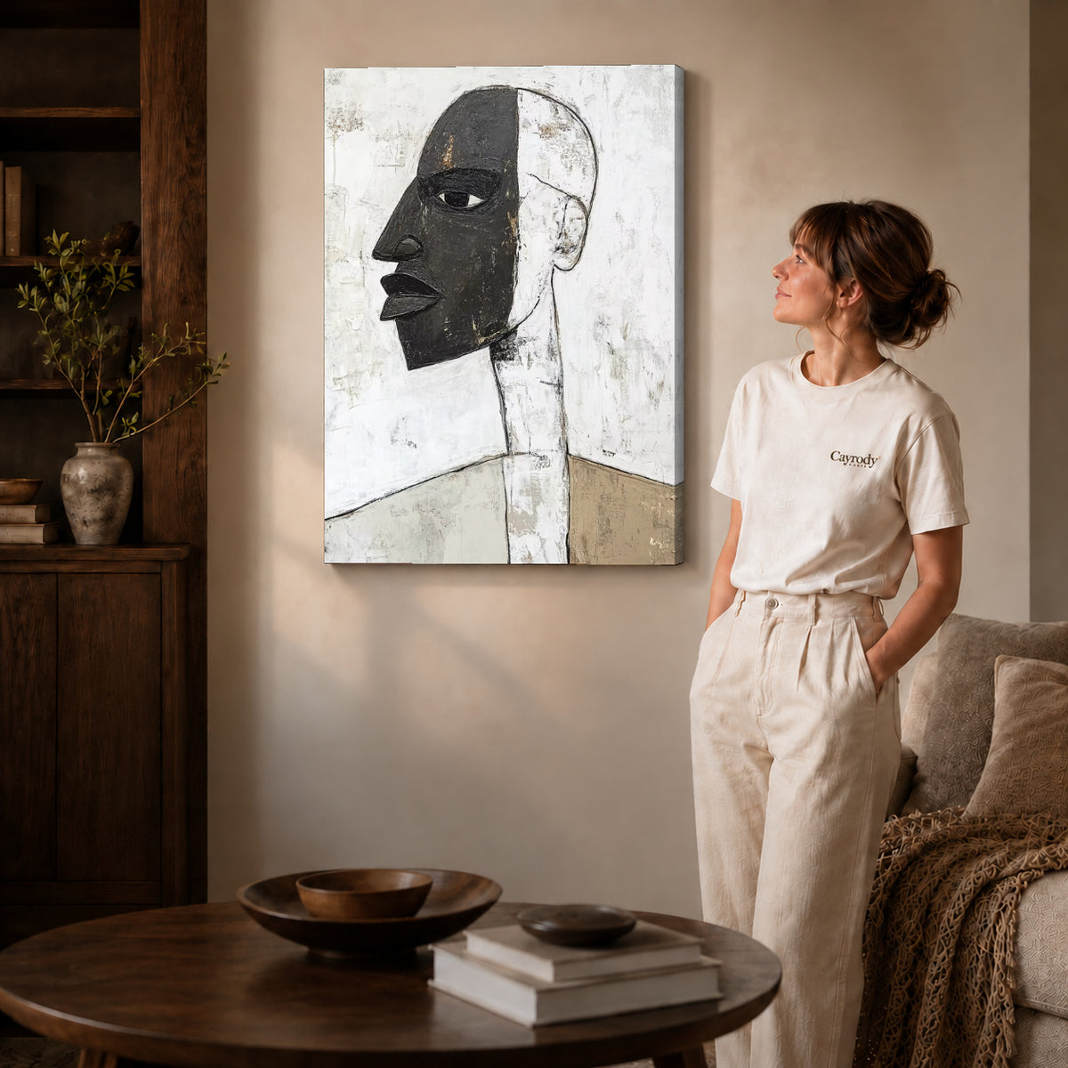 Abstract profile canvas art on gallery-wrapped canvas with natural edge shading beside a standing woman.