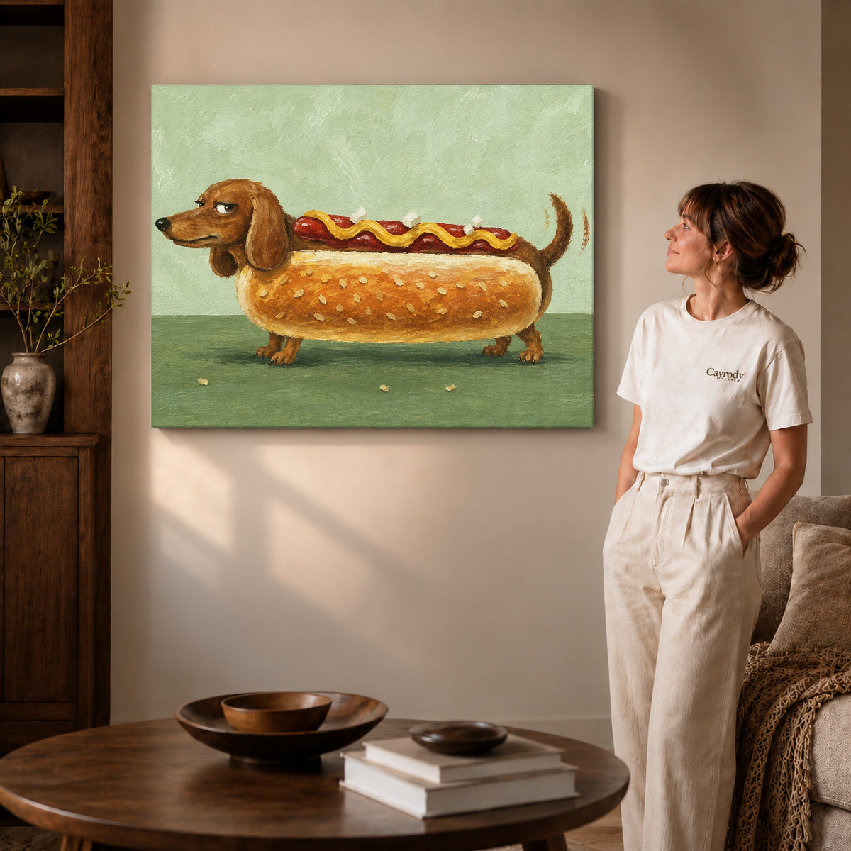 Dachshund hot dog canvas art on gallery-wrapped canvas with natural edge shading beside a standing woman.