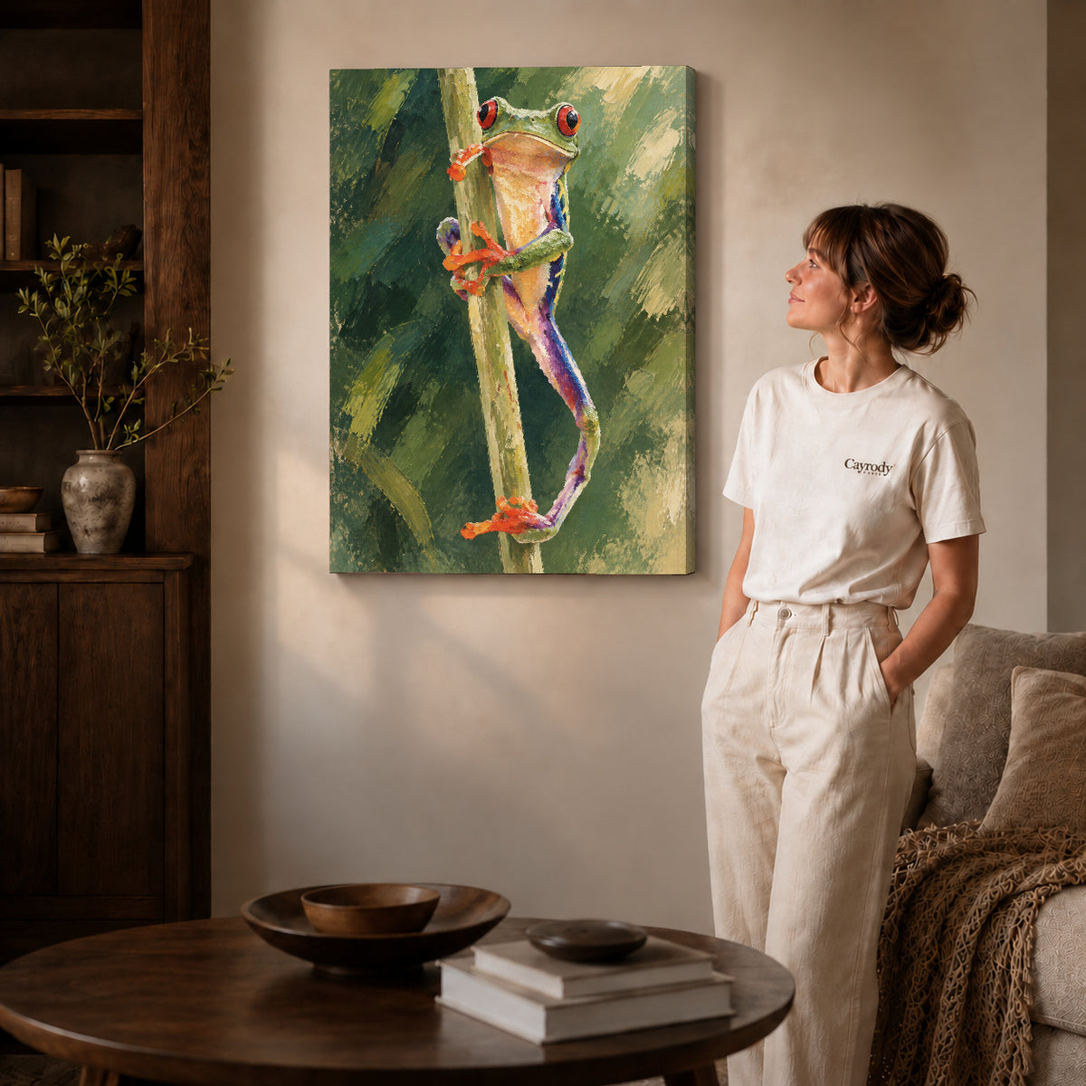 Tree frog canvas art on gallery-wrapped canvas with natural edge shading beside a standing woman.