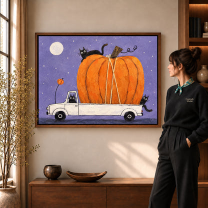 Pumpkin truck cats canvas art shown in the walnut frame option against a softly lit living room wall.