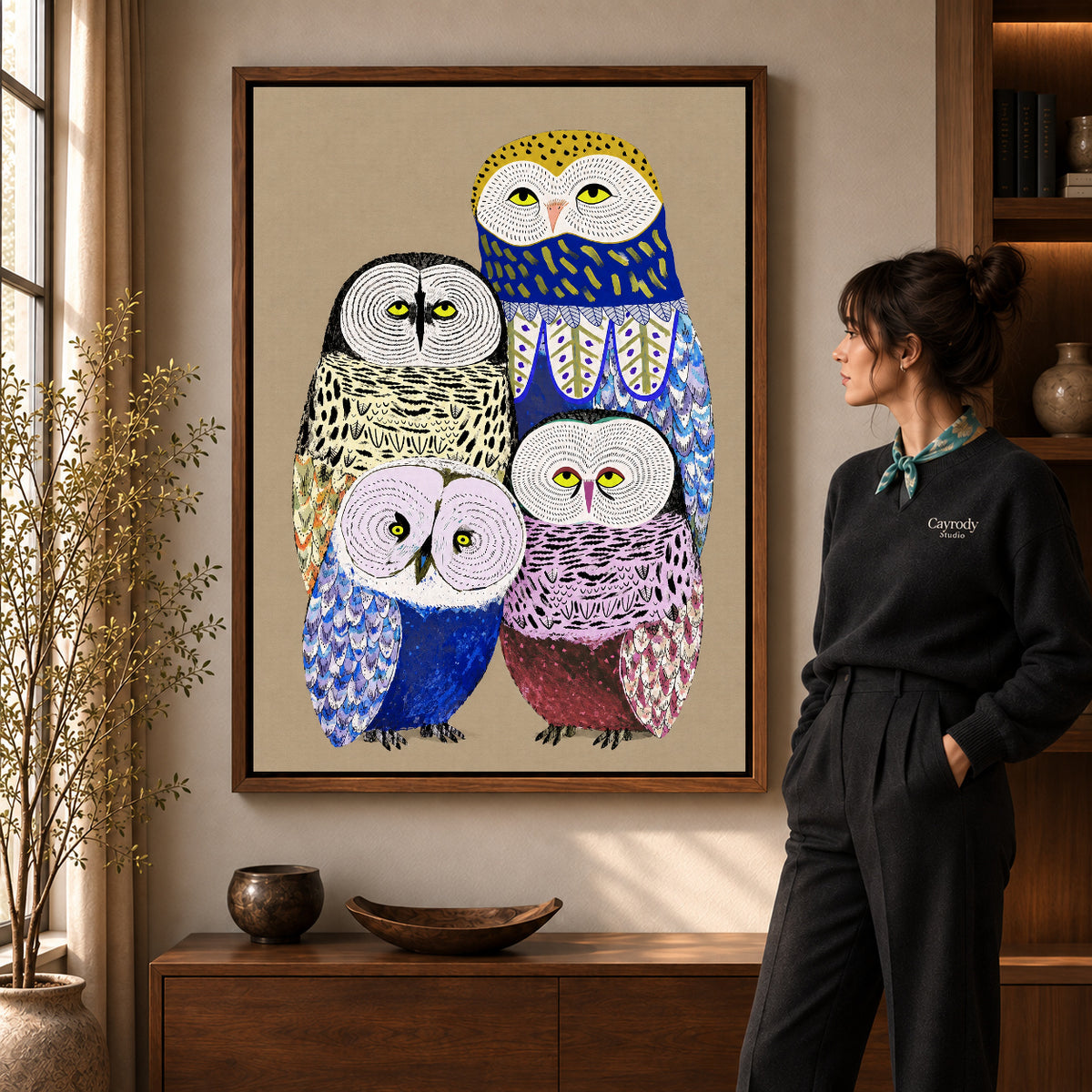 Owl family canvas art shown in the walnut frame option within a warm living room.