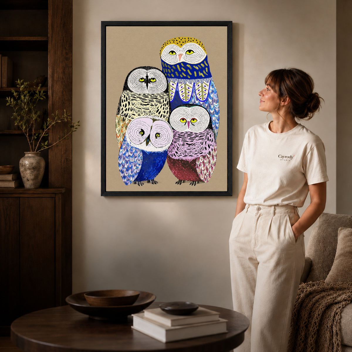 Owl family canvas art shown in the black frame option against a softly lit wall.