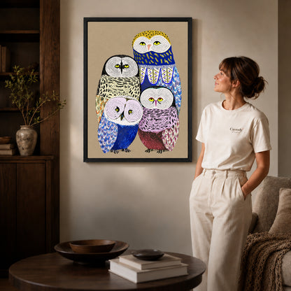 Owl family canvas art shown in the black frame option against a softly lit wall.