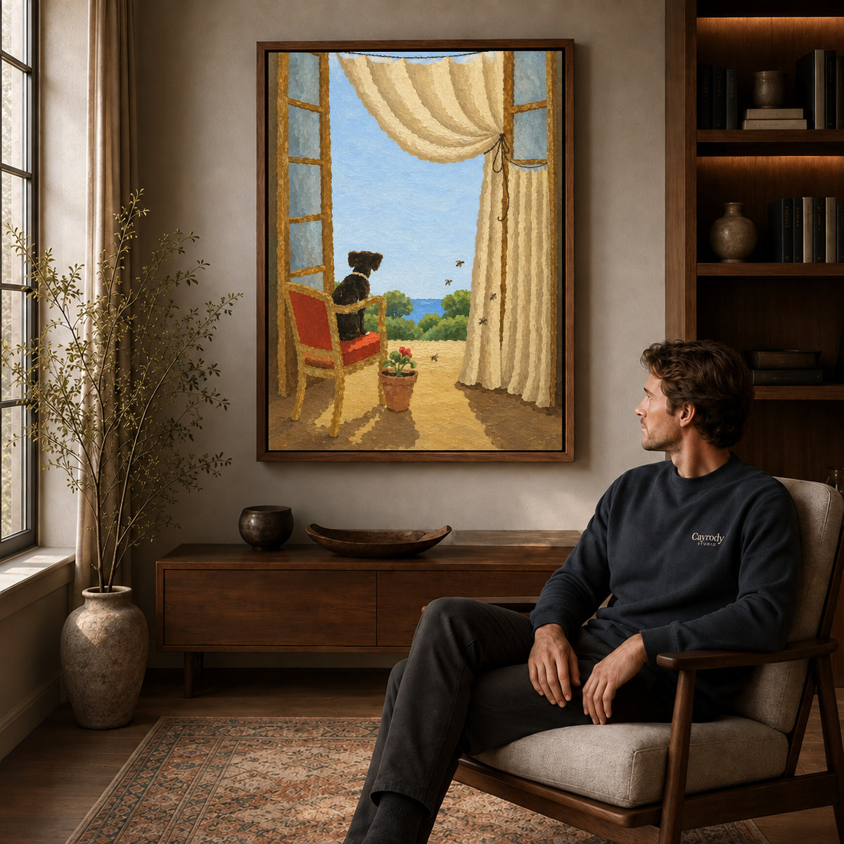 Window dog canvas art in a walnut frame above a console beside a seated man.
