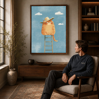 straw hat cat canvas art in a walnut frame above a console beside a seated man.