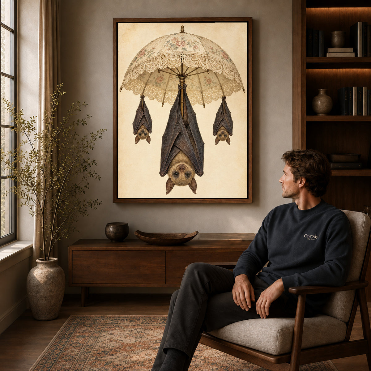 lace parasol bats canvas art in a walnut frame above a console beside a seated man.