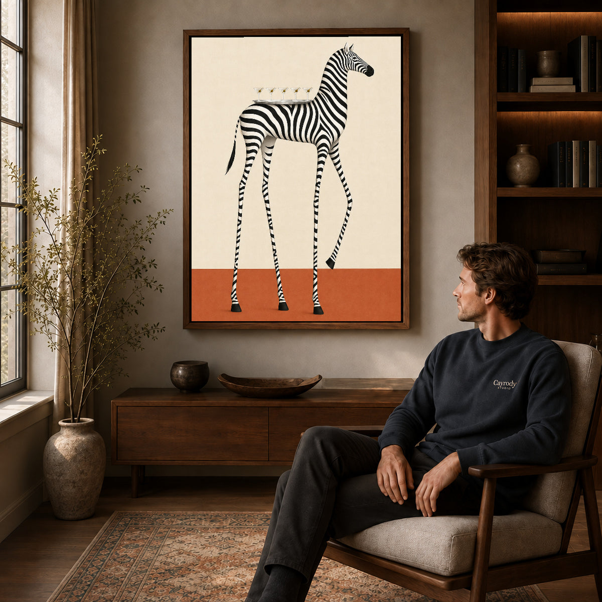 martini tray zebra canvas art in a walnut frame above a console beside a seated man.