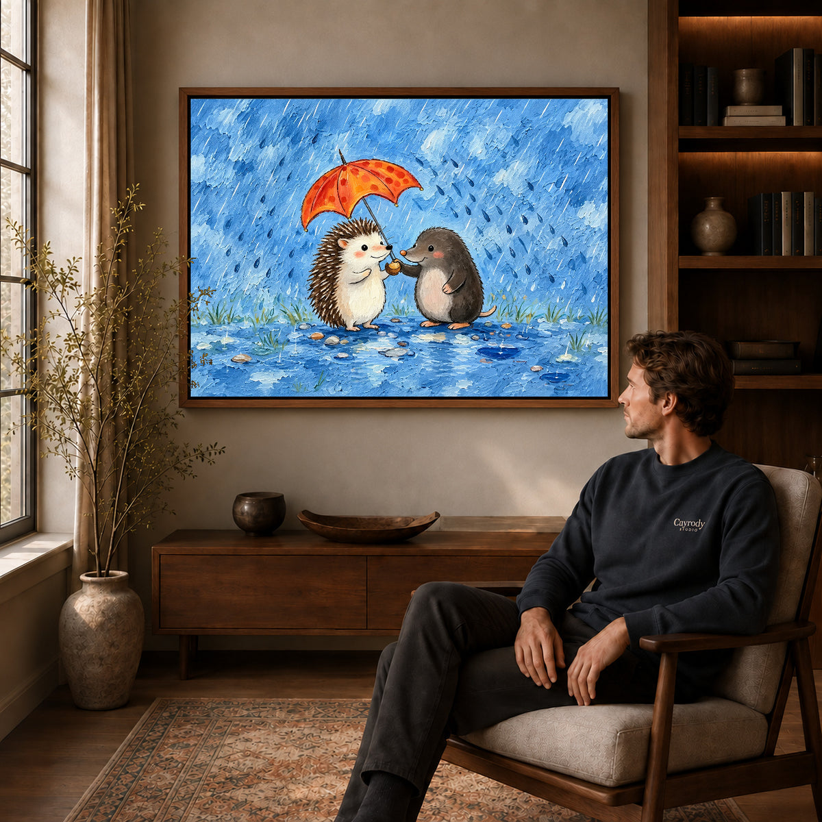 rainy hedgehog friends canvas art in a walnut frame above a console beside a seated man.