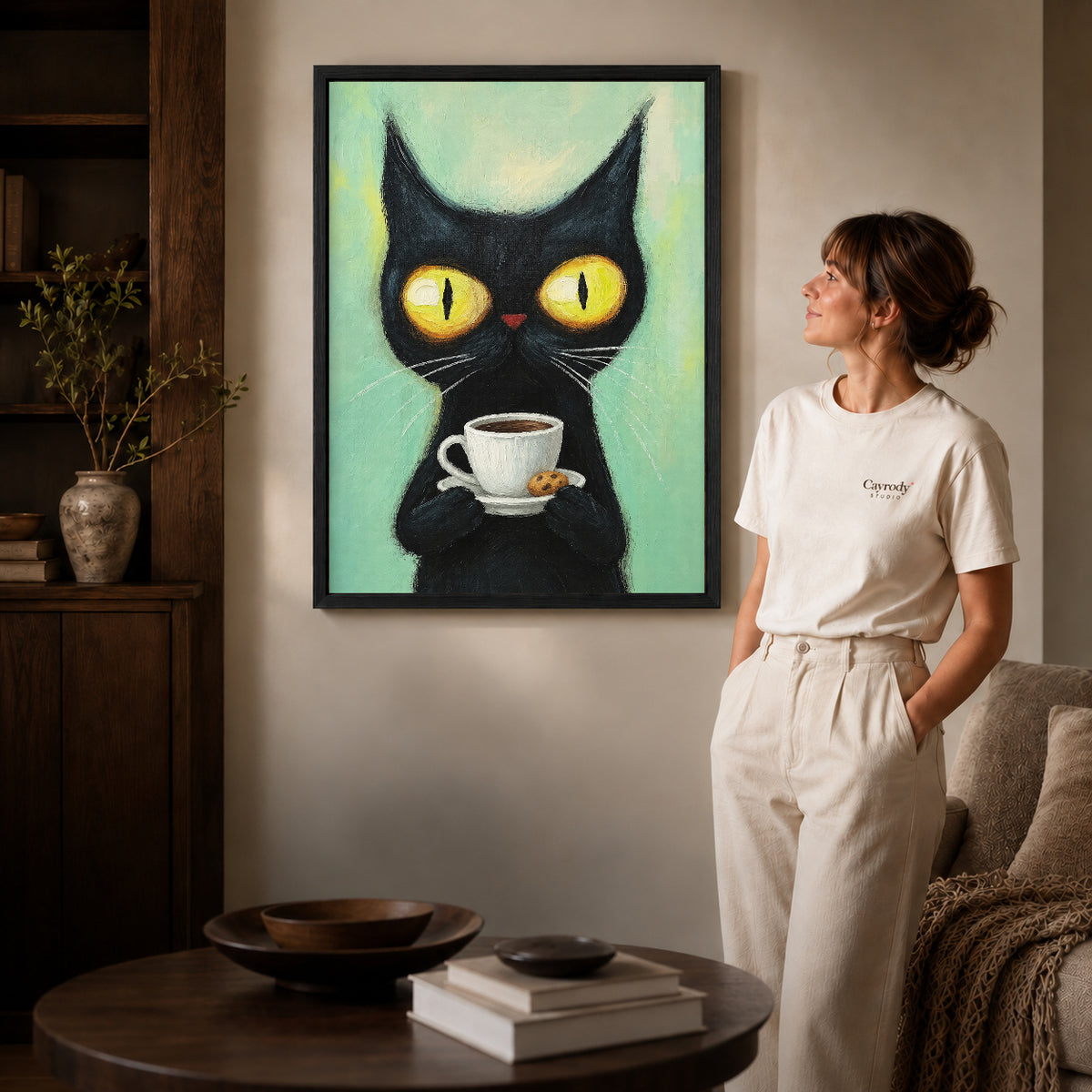 black coffee cat canvas art shown in the black frame option against a softly lit wall.