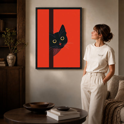 peeking black cat canvas art in a black frame beside a woman and round wooden table.