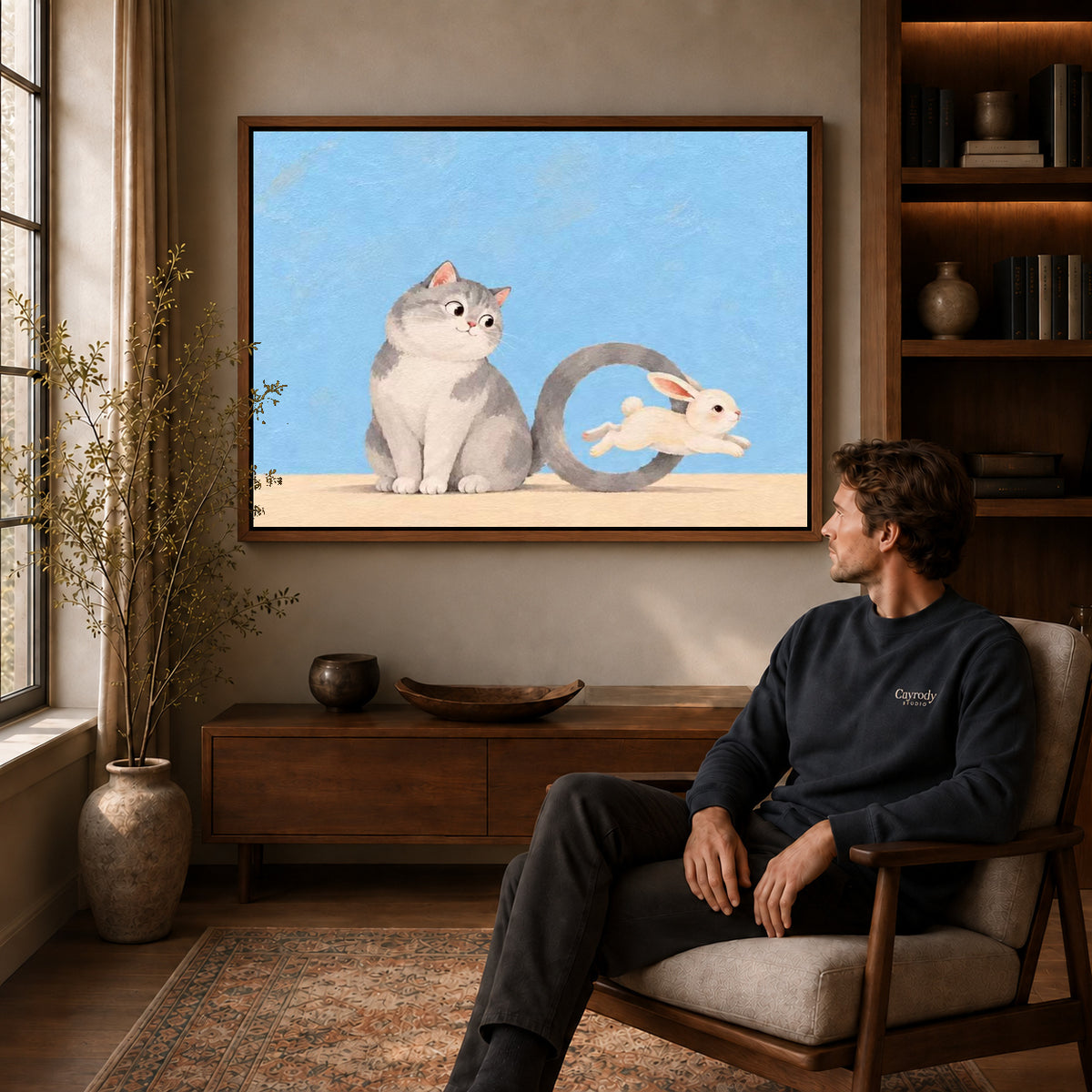 playful tail hoop canvas art in a walnut frame above a console beside a seated man.
