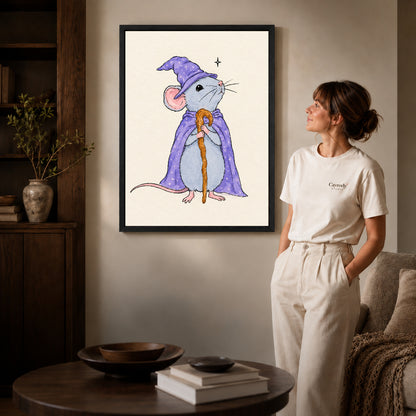 whimsical wizard mouse canvas art in a black frame beside a woman and round wooden table.