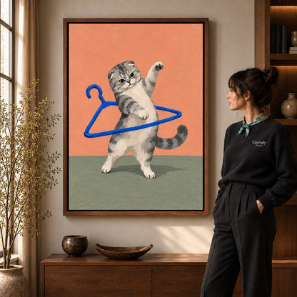 playful hanger kitten canvas art in a walnut frame beside a standing woman and wooden console.