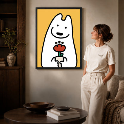 cheerful flower friend canvas art in a black frame beside a woman and round wooden table.