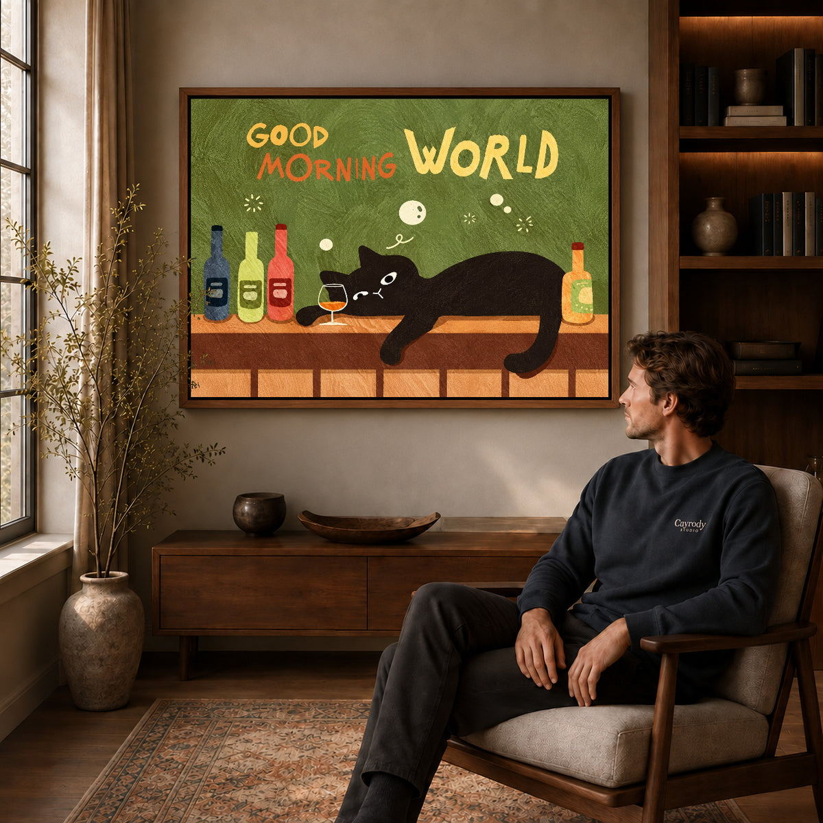 playful morning bar cat canvas art in a walnut frame above a console beside a seated man.