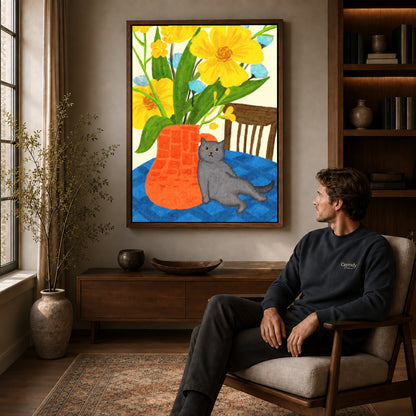 expressive floral cat canvas art in a walnut frame above a console beside a seated man.