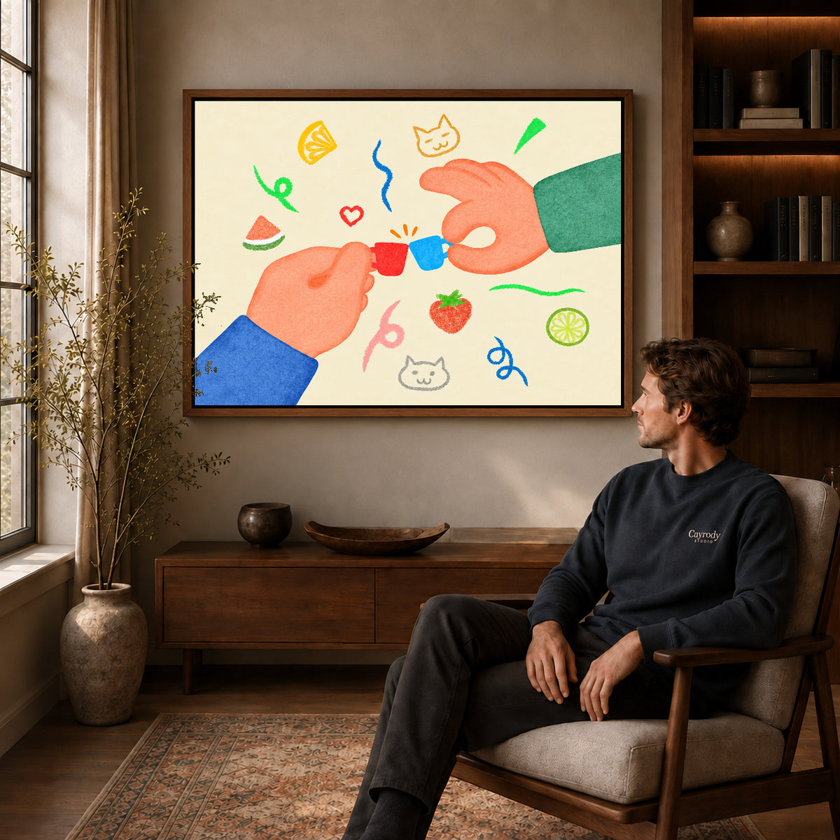 playful tiny cup cheers canvas art in a walnut frame above a console beside a seated man.
