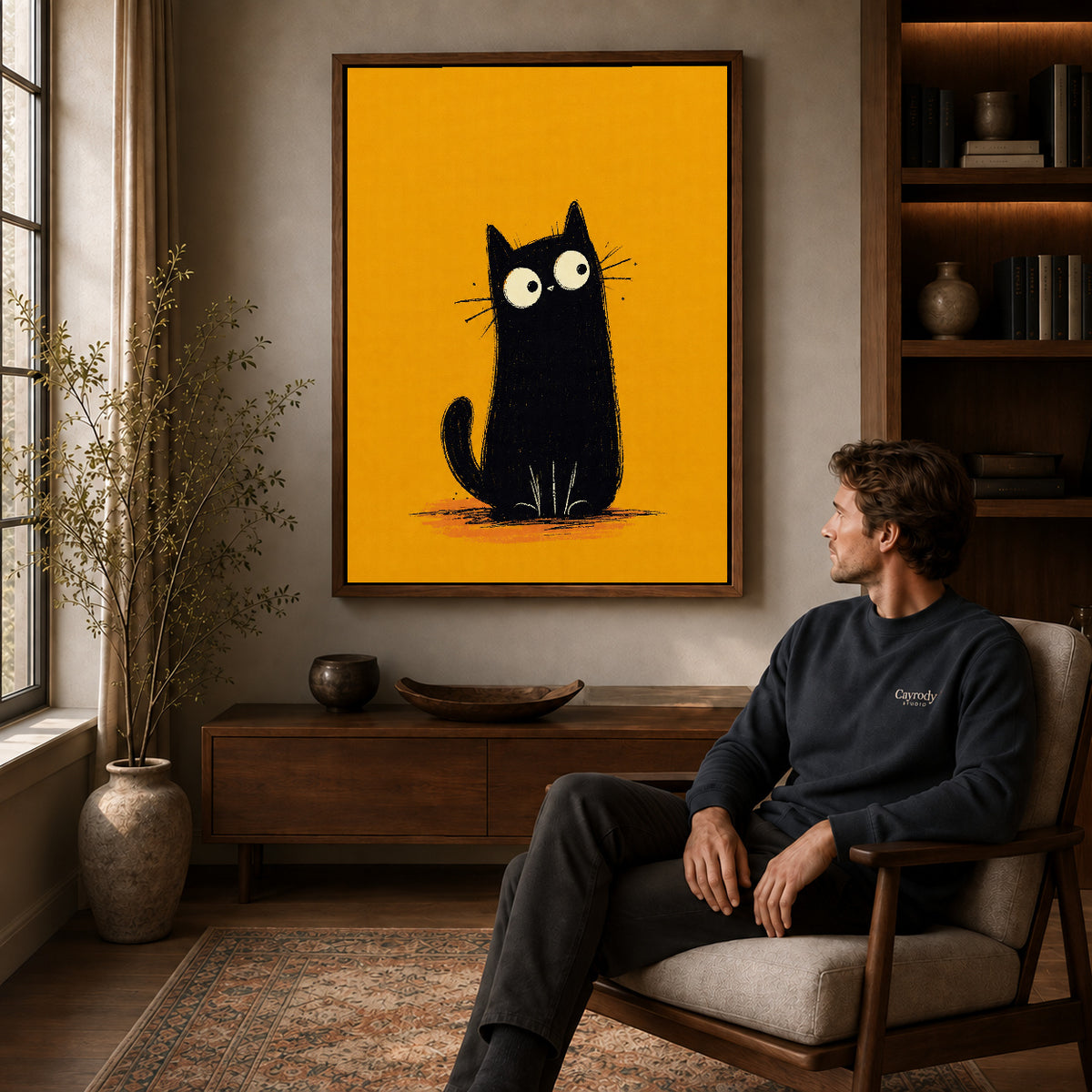 minimalist mustard cat canvas art in a walnut frame above a console beside a seated man.