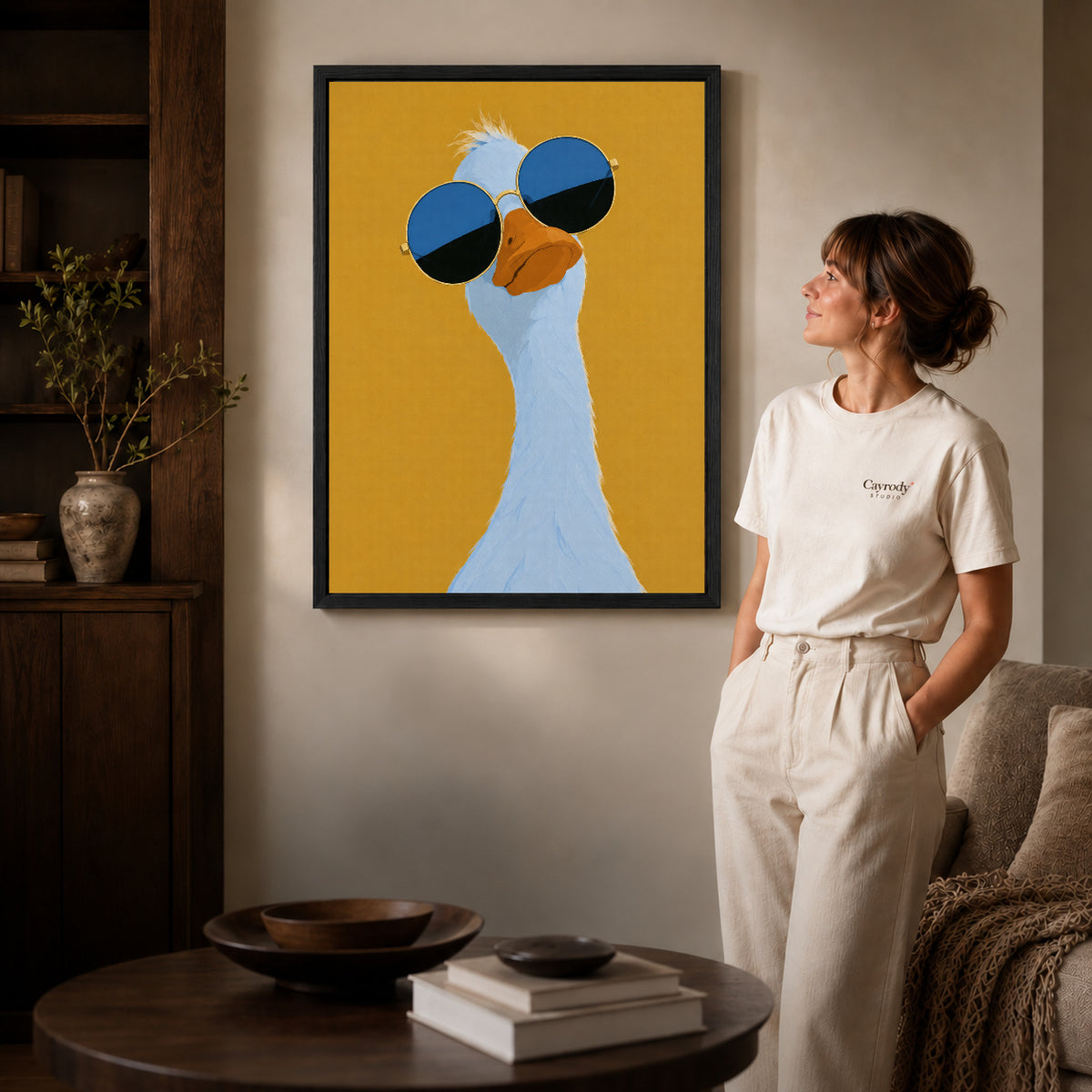 sunglasses goose portrait canvas art shown in the black frame option against a softly lit wall.