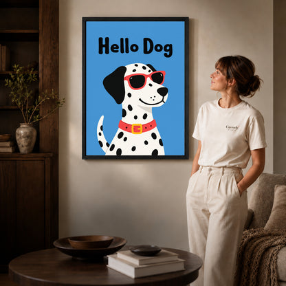 playful hello dog canvas art in a black frame beside a woman and round wooden table.