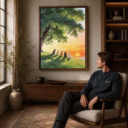 peaceful sunset cats canvas art in a walnut frame above a console beside a seated man.