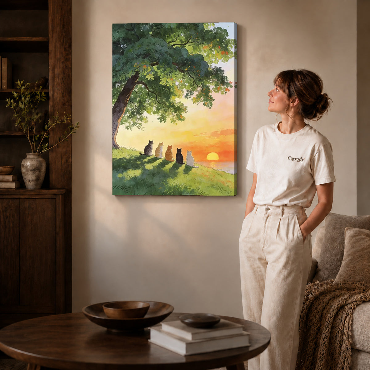 peaceful sunset cats canvas art on gallery-wrapped canvas with natural edge shading beside a standing woman.