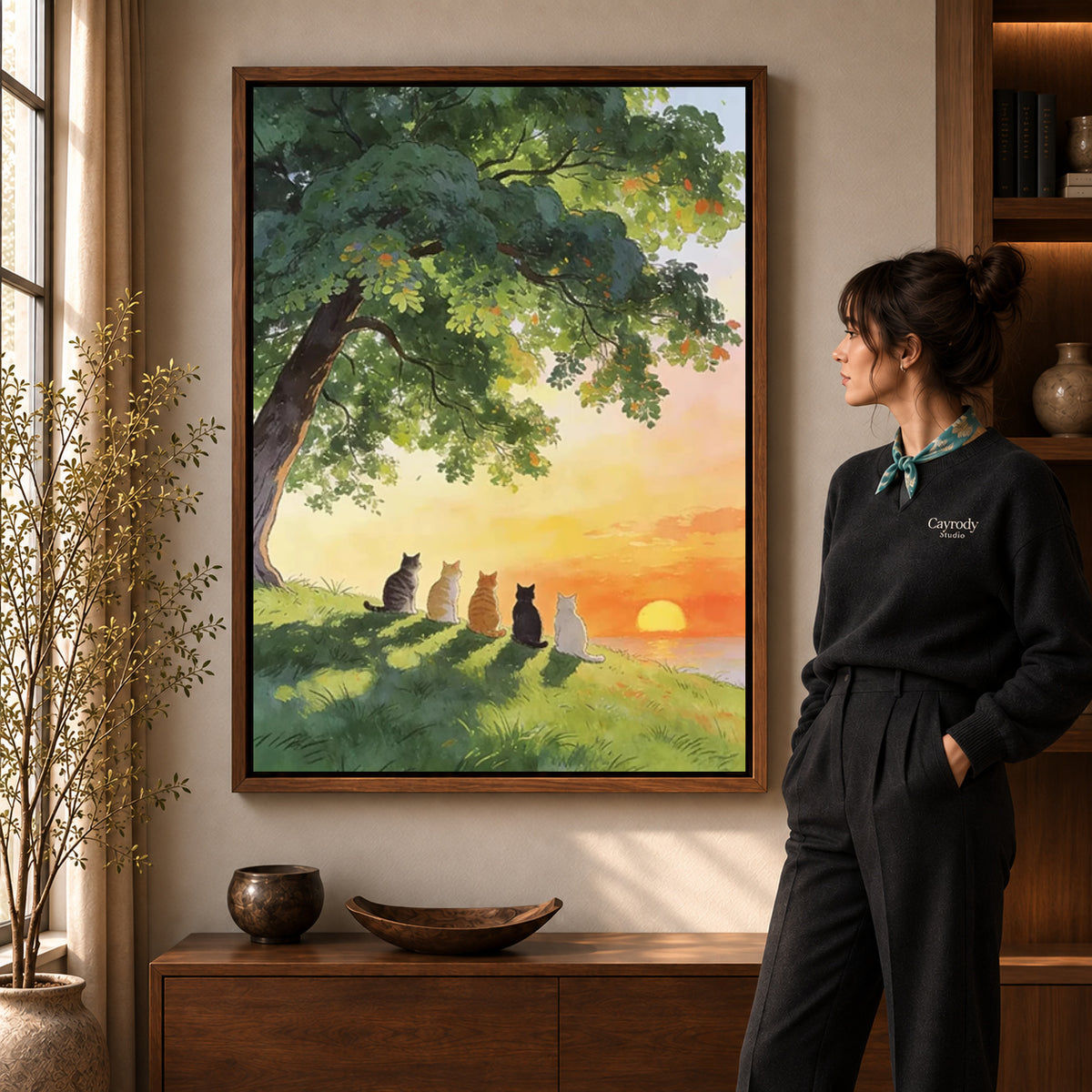 peaceful sunset cats canvas art shown in the walnut frame option within a warm living room.