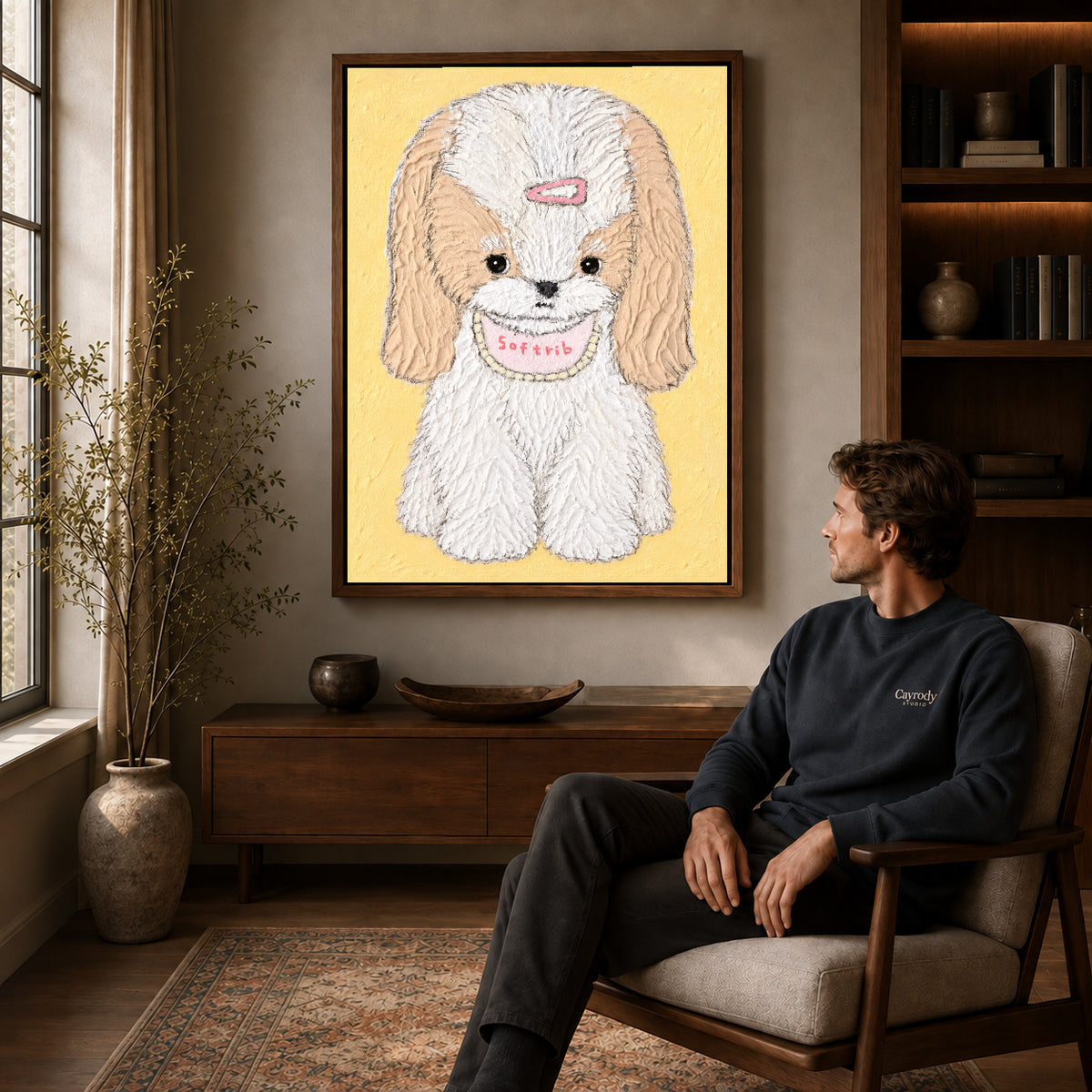 sweet long eared puppy canvas art in a walnut frame above a console beside a seated man.
