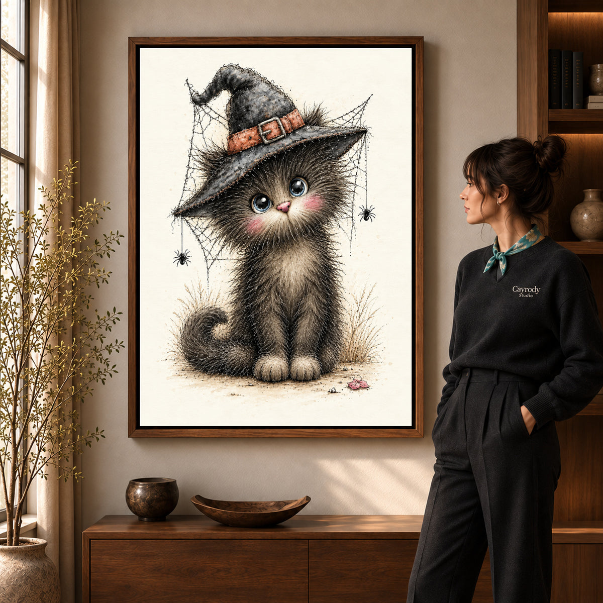 whimsical witch kitten canvas art shown in the walnut frame option within a warm living room.