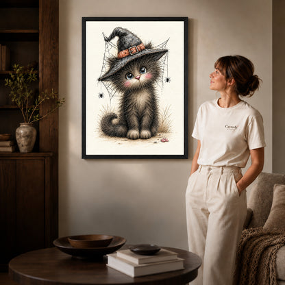 whimsical witch kitten canvas art shown in the black frame option against a softly lit wall.