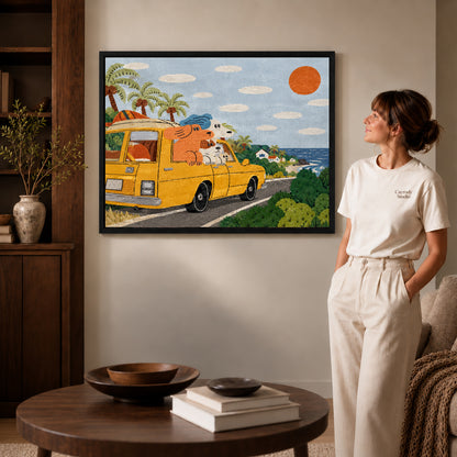 coastal camper dogs canvas art in a black frame beside a woman and round wooden table.