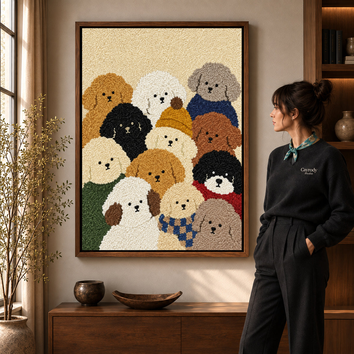cozy curly dog friends canvas art in a walnut frame beside a standing woman and wooden console.