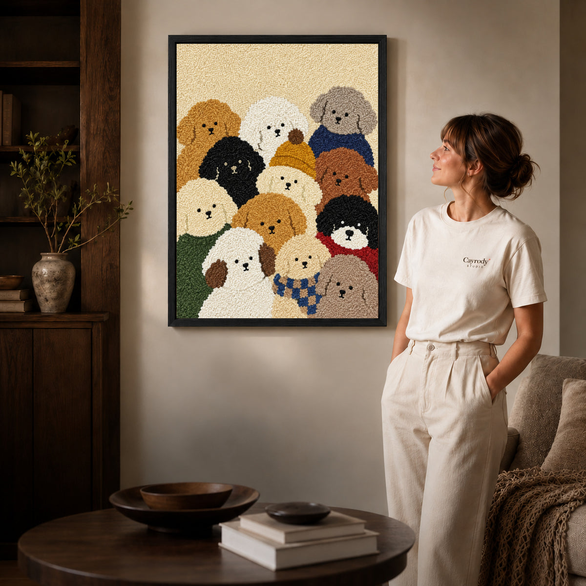 cozy curly dog friends canvas art shown in the black frame option against a softly lit wall.