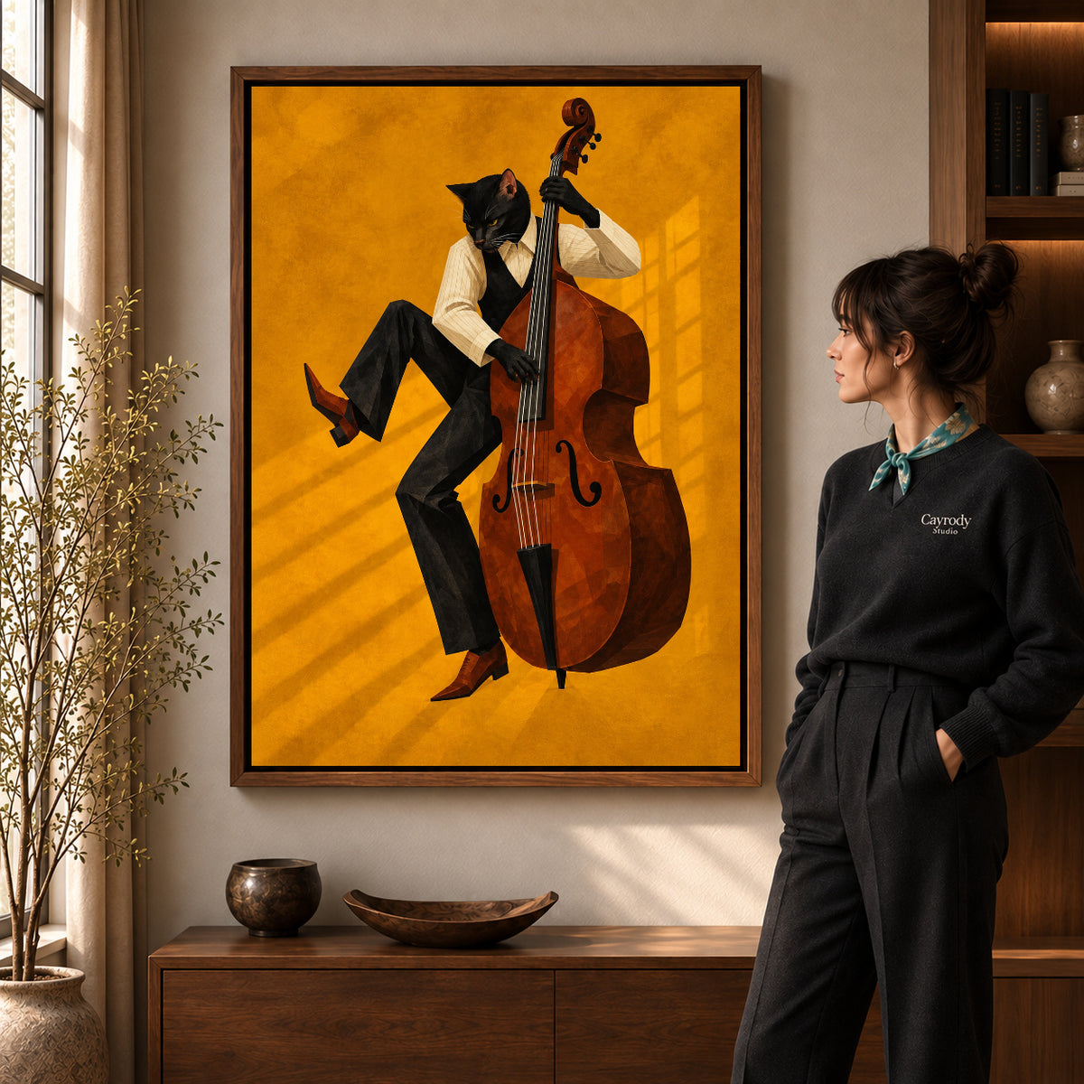 golden jazz bassist cat canvas art in a walnut frame beside a standing woman and wooden console.