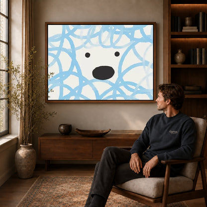 playful curly dog canvas art in a walnut frame above a console beside a seated man.